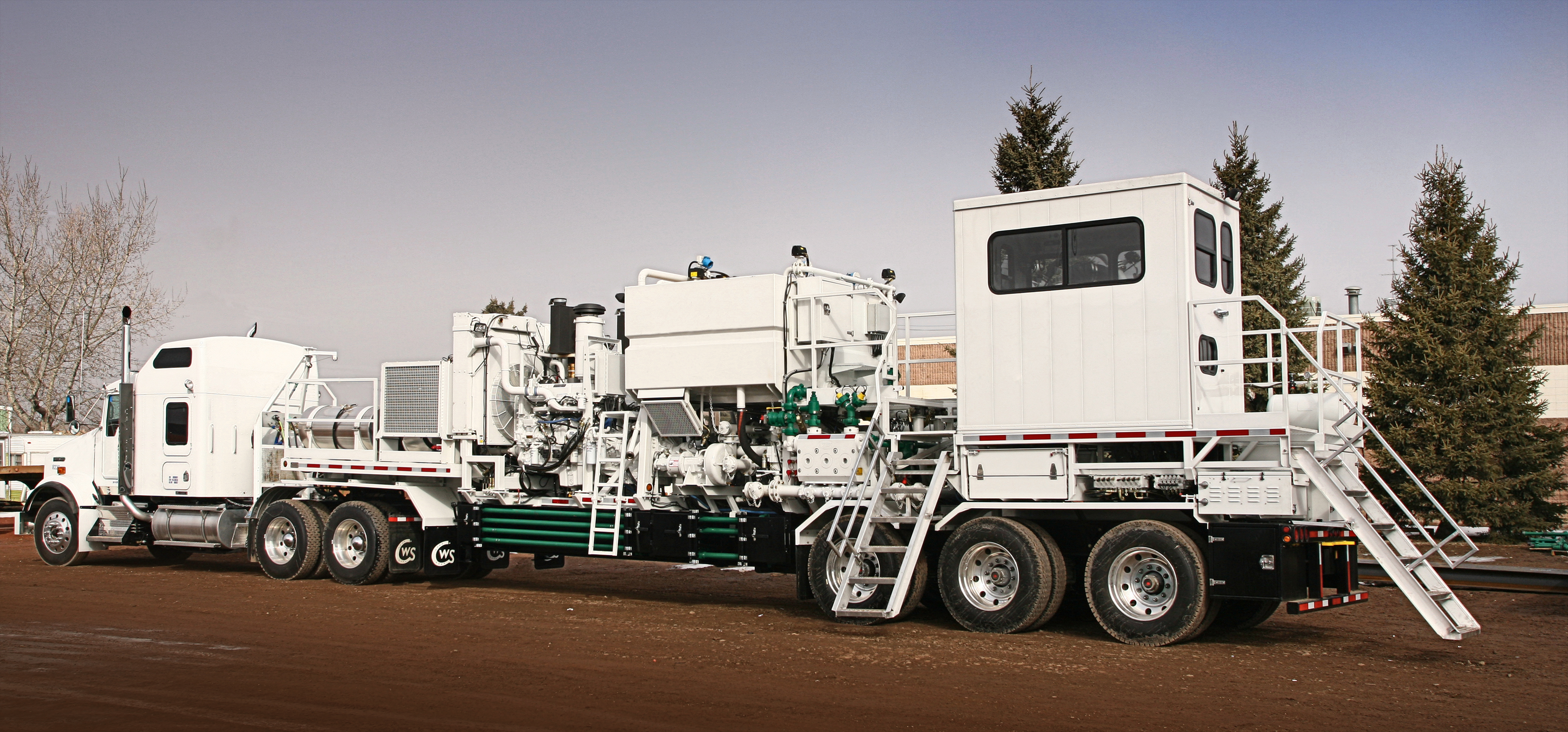fully loaded white fracking and well servicing rig